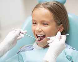 Young girl undergoing a dental checkup and cleaning