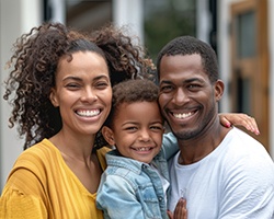 Family smiling and showing off healthy teeth