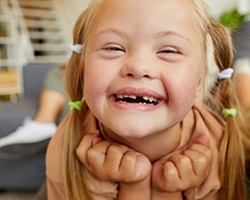 a special needs girl smiling with a missing tooth