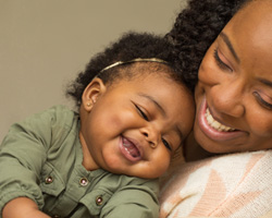 Happy mother and baby cuddling