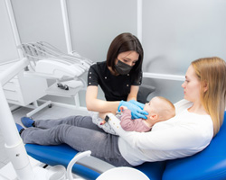 Baby being treated for lip and tongue tie at dentist 